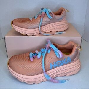 Hoka One One Ricon 3 Woman’s running shoe in Shell Coral and Blue.